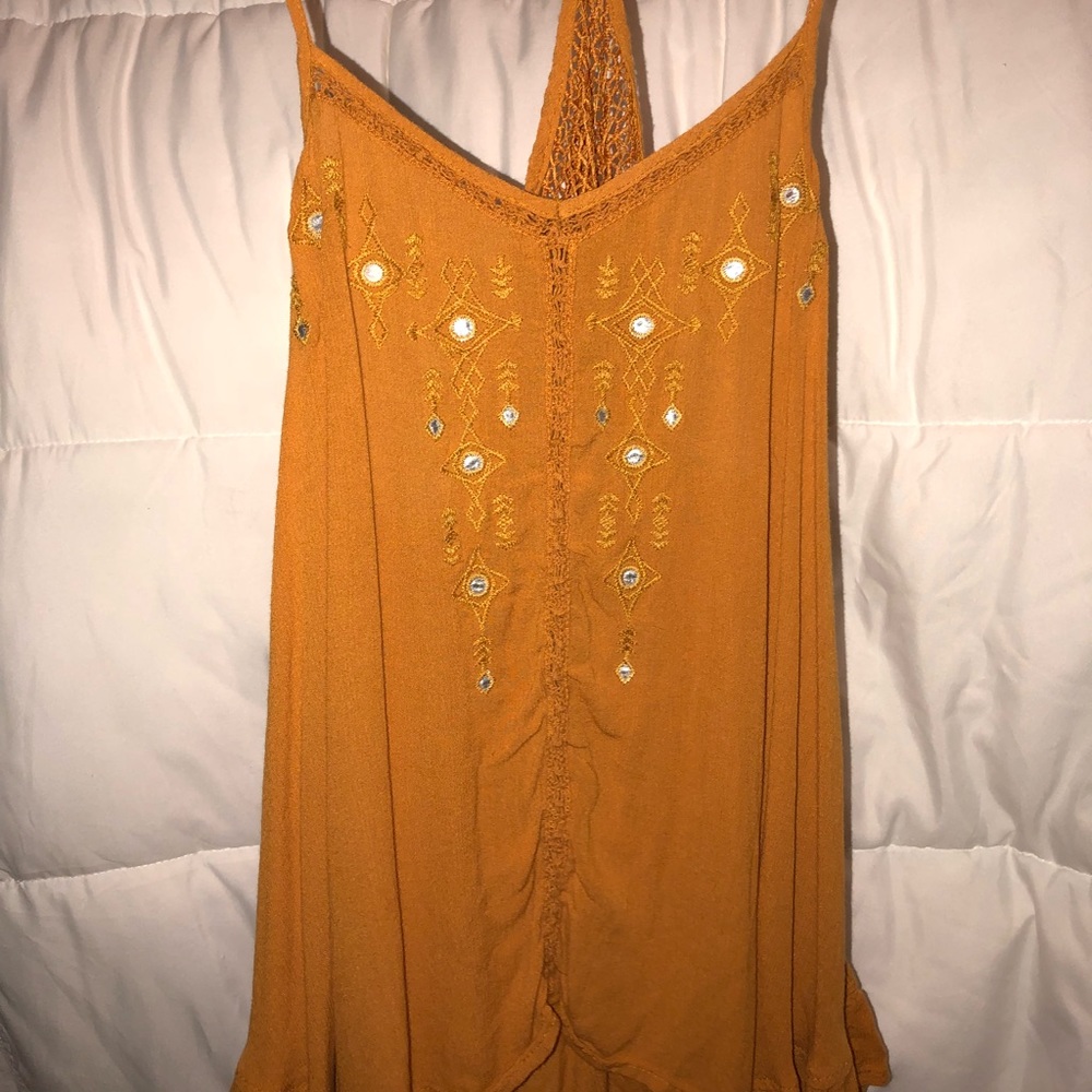 a golden colored tank top